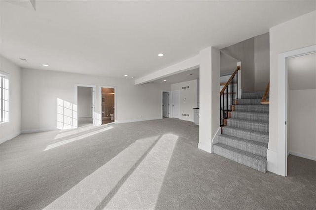 unfurnished living room with visible vents, baseboards, carpet floors, recessed lighting, and stairs