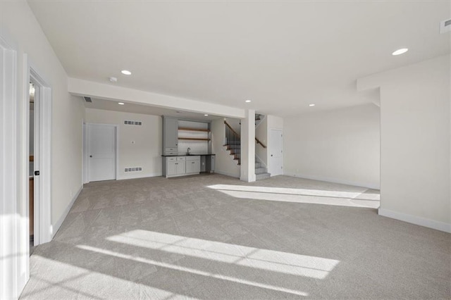 basement featuring recessed lighting, carpet flooring, and visible vents