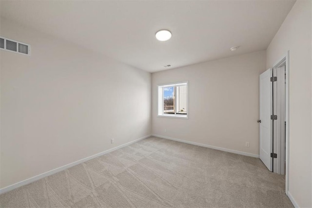 empty room with light carpet, baseboards, and visible vents