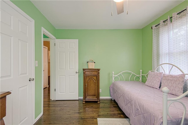 bedroom with baseboards, dark wood finished floors, and a ceiling fan