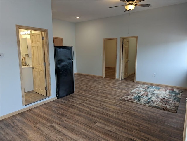 700 W 40th Hwy, Sweet Springs, MO 65351 - empty room with dark wood-type flooring, baseboards, and a ceiling fan