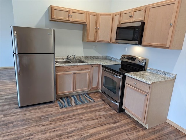 700 W 40th Hwy, Sweet Springs, MO 65351 - kitchen with light stone counters, a sink, stainless steel appliances, light brown cabinets, and dark wood-style floors