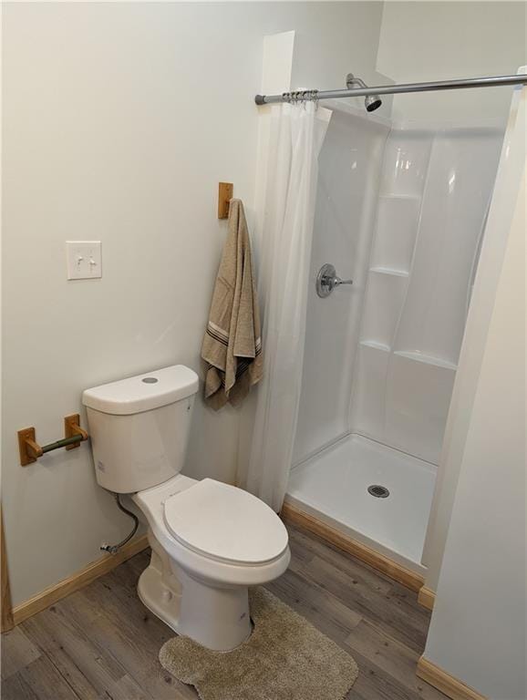 700 W 40th Hwy, Sweet Springs, MO 65351 - full bathroom with toilet, baseboards, a stall shower, and wood finished floors