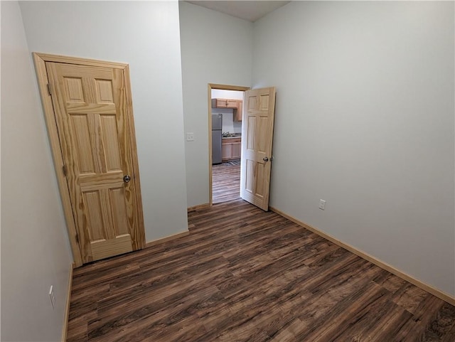 700 W 40th Hwy, Sweet Springs, MO 65351 - spare room with dark wood-type flooring and baseboards