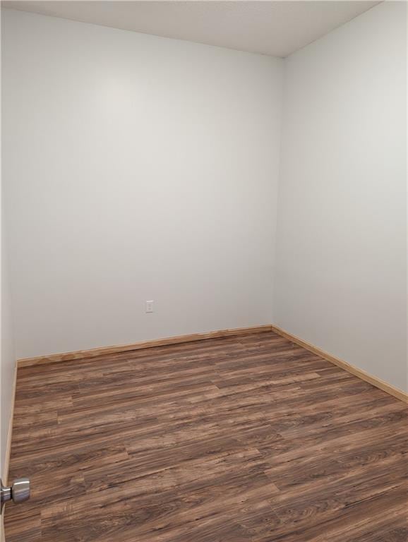 700 W 40th Hwy, Sweet Springs, MO 65351 - spare room featuring wood finished floors and baseboards