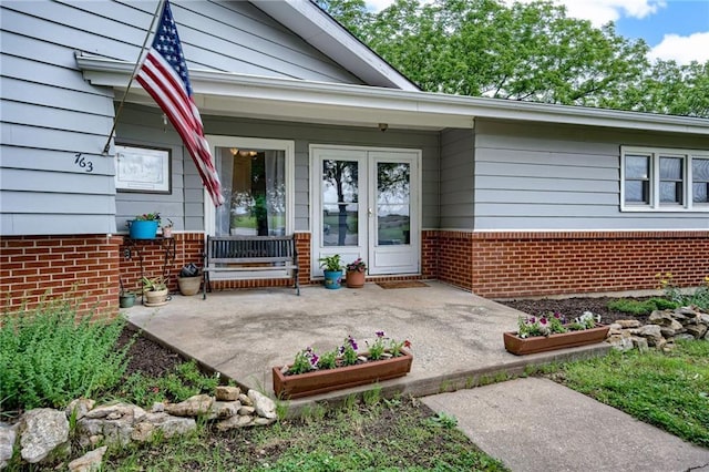 763 J Hwy, Peculiar, MO 64078 - view of exterior entry featuring french doors and brick siding