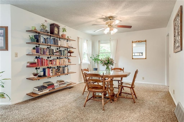 763 J Hwy, Peculiar, MO 64078 - dining room featuring a textured ceiling, ceiling fan, carpet, and baseboards