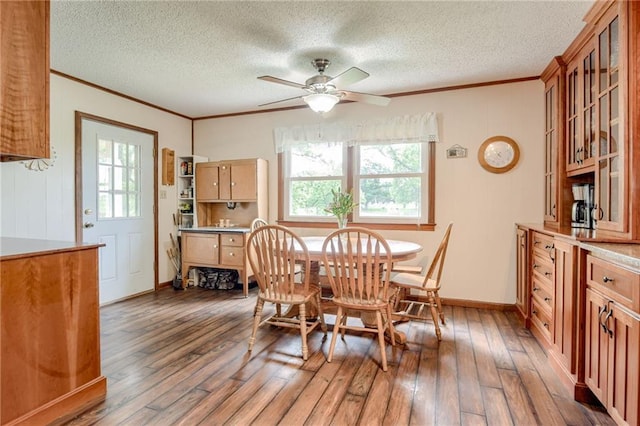 763 J Hwy, Peculiar, MO 64078 - dining area with crown molding, hardwood / wood-style floors, ceiling fan, a textured ceiling, and baseboards