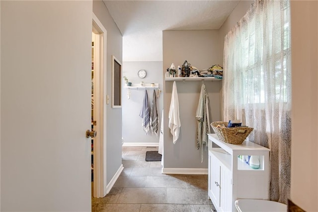 763 J Hwy, Peculiar, MO 64078 - bathroom with baseboards, tile patterned floors, and toilet
