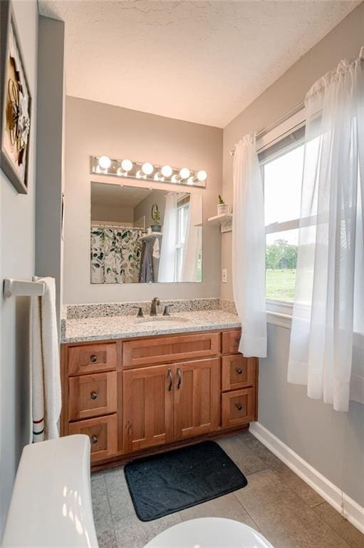 763 J Hwy, Peculiar, MO 64078 - full bathroom featuring vanity, baseboards, and tile patterned flooring
