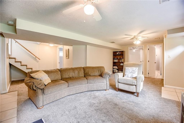 763 J Hwy, Peculiar, MO 64078 - tiled living area with carpet flooring, a ceiling fan, stairway, a textured ceiling, and baseboards