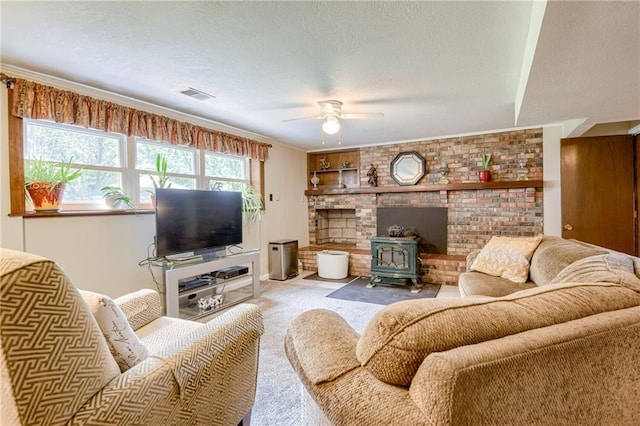 763 J Hwy, Peculiar, MO 64078 - living room with a ceiling fan, a wood stove, carpet, and a textured ceiling