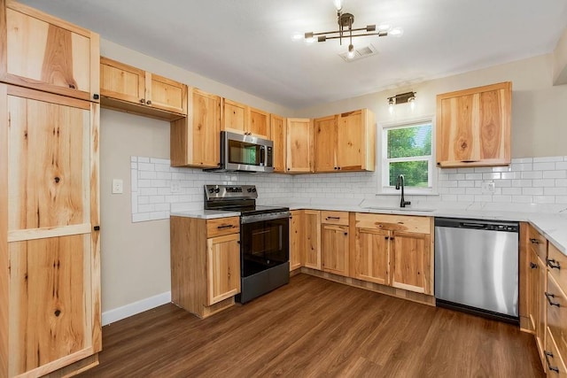 2308 NW 53rd Ter, Kansas City, MO 64151 - kitchen with appliances with stainless steel finishes, a sink, dark wood-style flooring, and light brown cabinetry