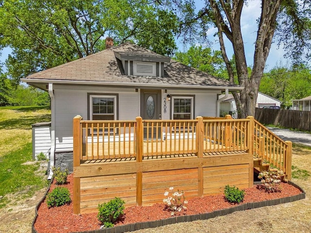 2308 NW 53rd Ter, Kansas City, MO 64151 - rear view of property featuring a chimney, roof with shingles, and stairs