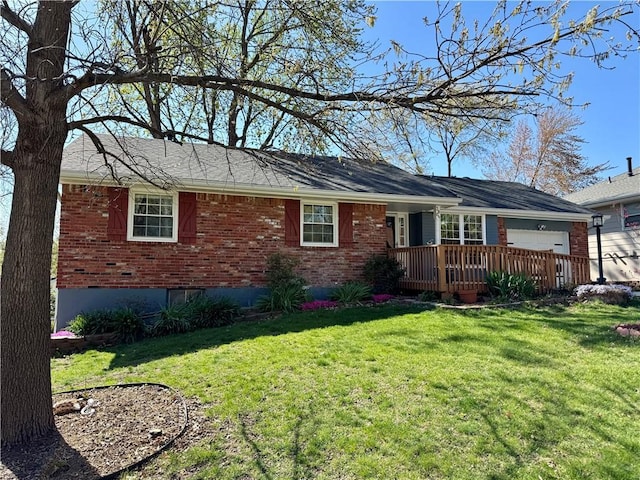 3804 S Drumm Ave, Independence, MO 64055 - rear view of house with a lawn, brick siding, and a garage