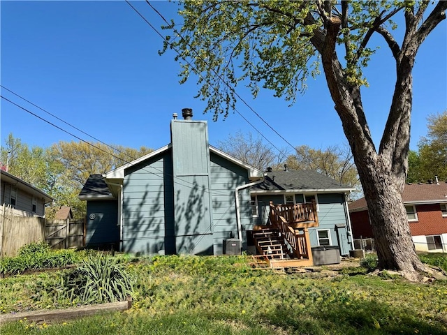 3804 S Drumm Ave, Independence, MO 64055 - back of house with a chimney, stairs, fence, and a deck