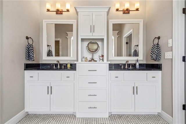 full bathroom with vanity and baseboards