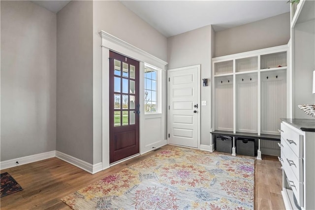 mudroom with light wood-type flooring and baseboards