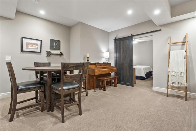 dining room with light carpet, recessed lighting, baseboards, and a barn door