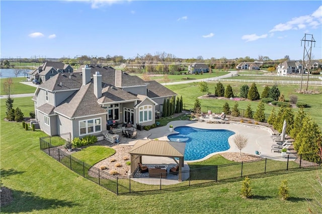 view of pool featuring a patio area, a fenced backyard, a gazebo, and a lawn