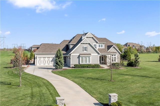 view of front of home featuring a shingled roof, driveway, a garage, and a front yard