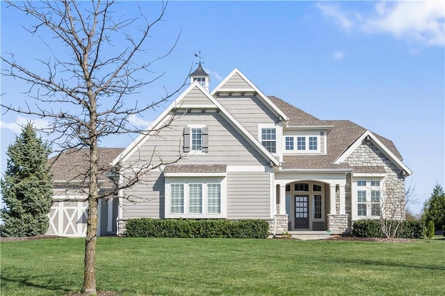 view of front of property with roof with shingles and a front lawn