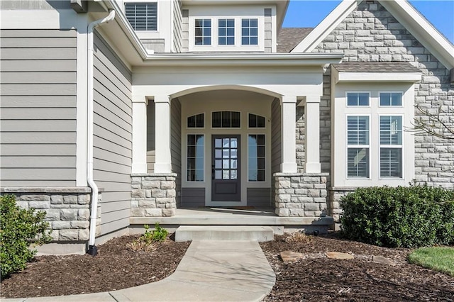 property entrance with stone siding and covered porch