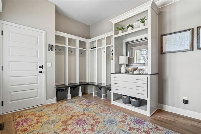 mudroom featuring visible vents, baseboards, and wood finished floors