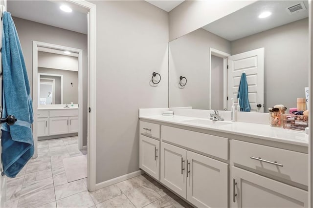 full bathroom with visible vents, baseboards, and vanity