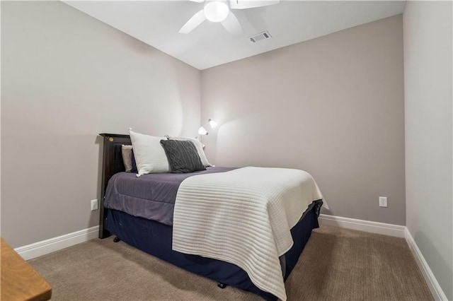 carpeted bedroom with visible vents, baseboards, and a ceiling fan