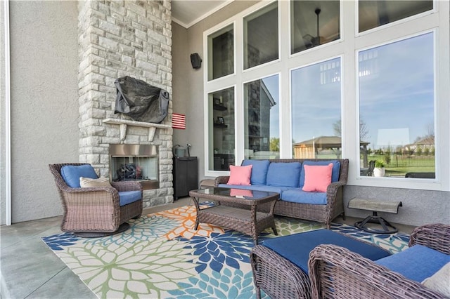view of patio / terrace with an outdoor living space with a fireplace