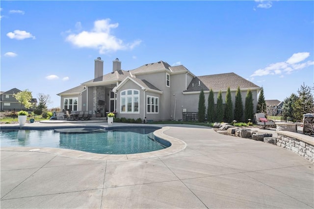 outdoor pool featuring a patio area and fence