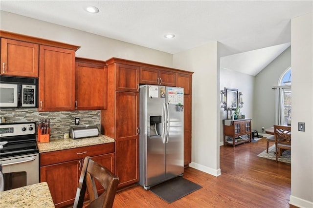 kitchen with backsplash, wood finished floors, light stone counters, baseboards, and stainless steel appliances
