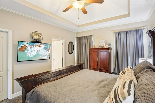 carpeted bedroom with baseboards, ceiling fan, and a tray ceiling