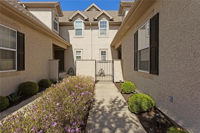 2118 NE 107th Ter, Kansas City, MO 64155 - doorway to property featuring stucco siding and a gate