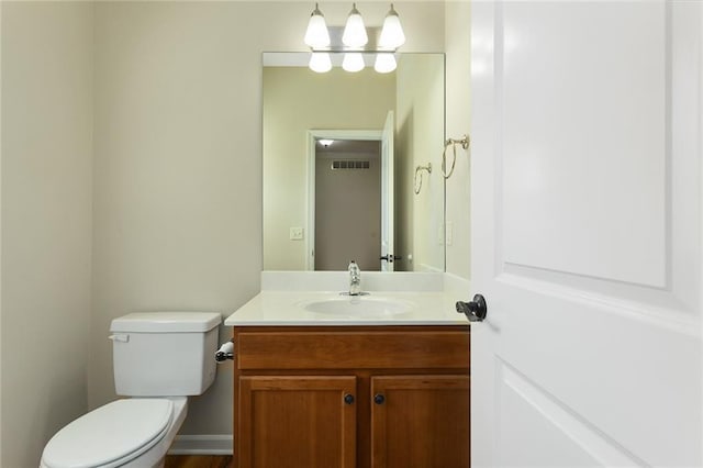 2118 NE 107th Ter, Kansas City, MO 64155 - half bathroom featuring visible vents, toilet, and vanity