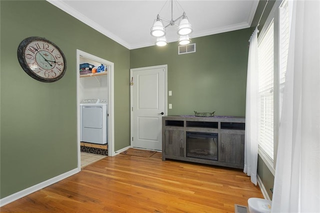 2118 NE 107th Ter, Kansas City, MO 64155 - unfurnished dining area featuring visible vents, wood finished floors, crown molding, and separate washer and dryer