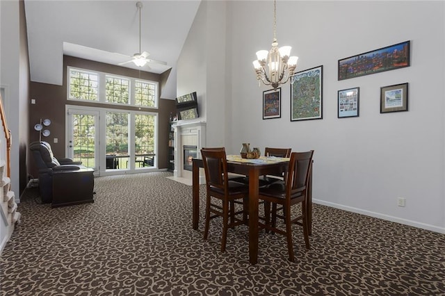 2118 NE 107th Ter, Kansas City, MO 64155 - carpeted dining space with baseboards, high vaulted ceiling, a fireplace with flush hearth, and ceiling fan with notable chandelier
