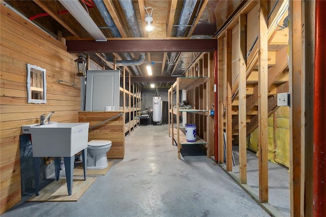 2118 NE 107th Ter, Kansas City, MO 64155 - unfinished basement with wooden walls, water heater, and a sink
