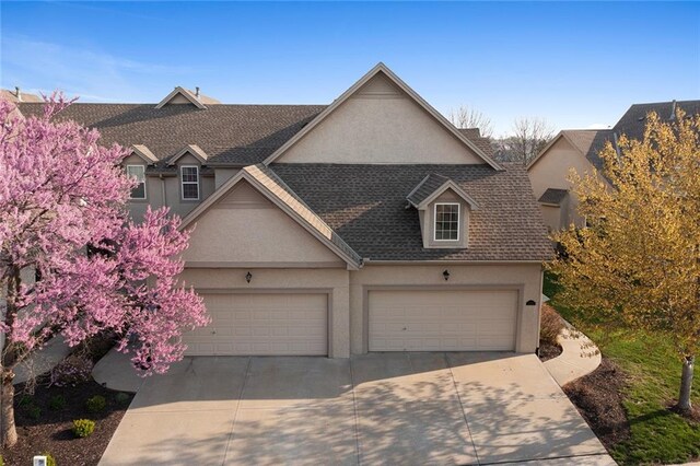 2118 NE 107th Ter, Kansas City, MO 64155 - view of front facade with a garage, a shingled roof, driveway, and stucco siding
