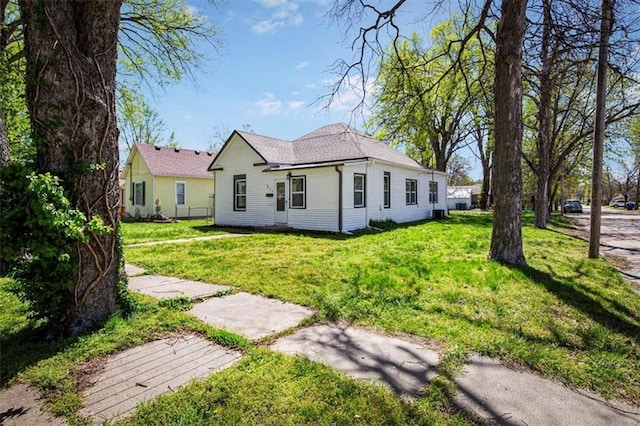 back of property with a lawn
