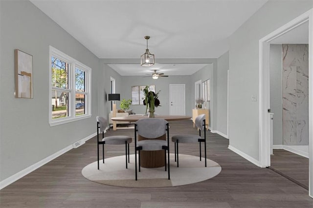 dining space with visible vents, baseboards, a ceiling fan, and dark wood finished floors