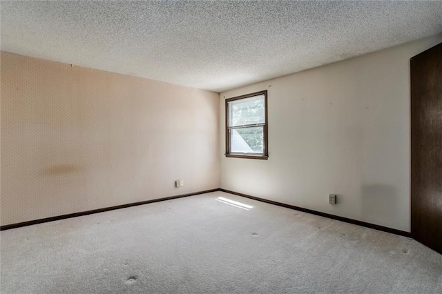 12253 W 104th St, Lenexa, KS 66215 - carpeted empty room featuring baseboards and a textured ceiling