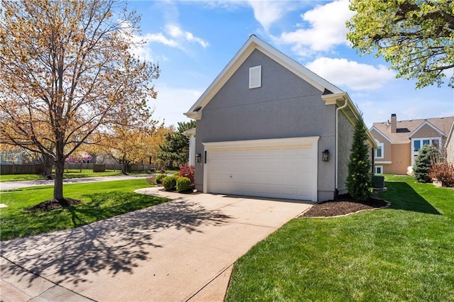 12314 England St, Overland Park, KS 66213 - view of side of property featuring concrete driveway, a yard, stucco siding, and an attached garage