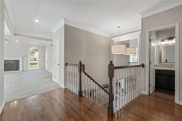 12314 England St, Overland Park, KS 66213 - hall featuring crown molding, an upstairs landing, and wood finished floors