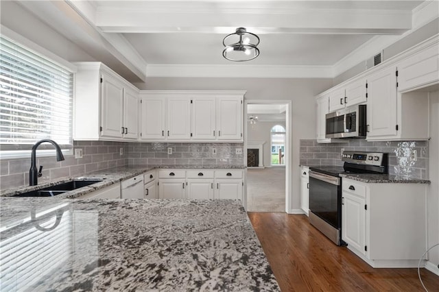 12314 England St, Overland Park, KS 66213 - kitchen with a sink, appliances with stainless steel finishes, white cabinetry, light stone countertops, and dark wood-type flooring