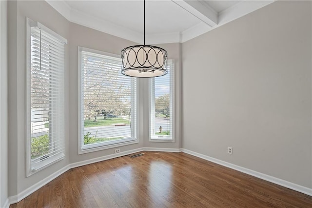 12314 England St, Overland Park, KS 66213 - unfurnished dining area featuring crown molding, baseboards, plenty of natural light, and wood finished floors