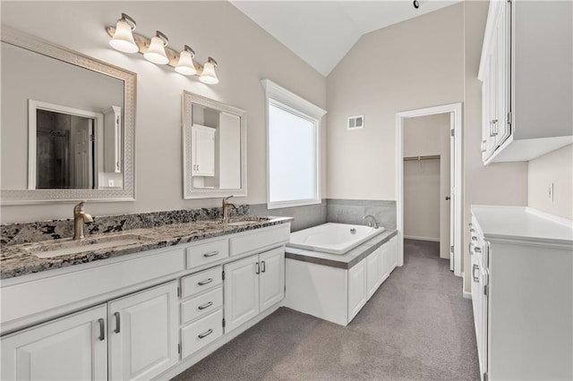 12314 England St, Overland Park, KS 66213 - bathroom featuring a bath, visible vents, a sink, and lofted ceiling