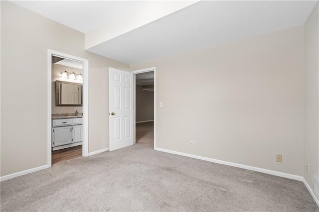 12314 England St, Overland Park, KS 66213 - unfurnished bedroom with carpet floors, baseboards, and connected bathroom