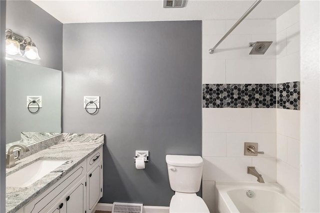 bathroom featuring bathtub / shower combination, toilet, vanity, and baseboards